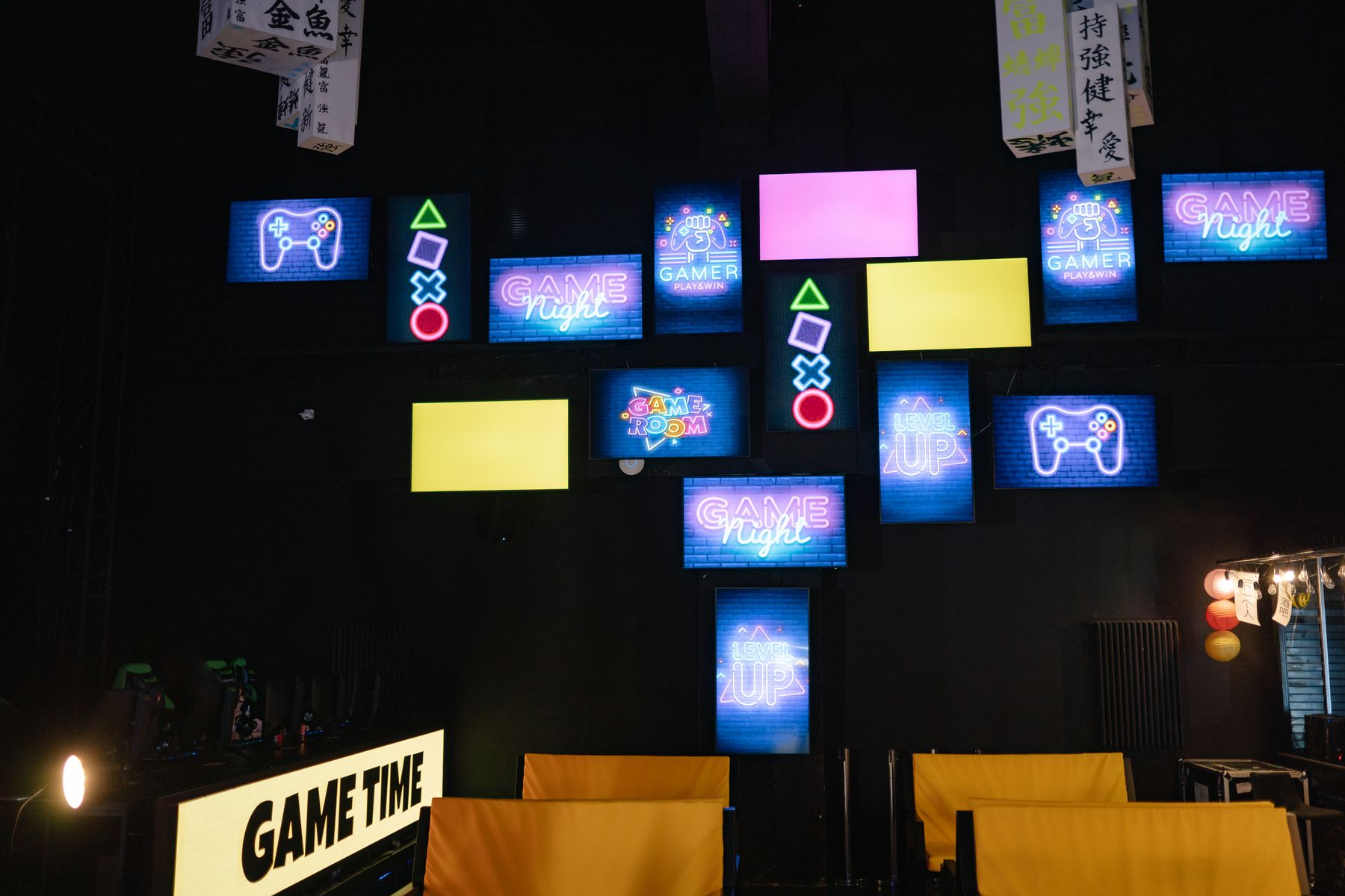 Wall of neon-lit classic arcade cabinets and game screens